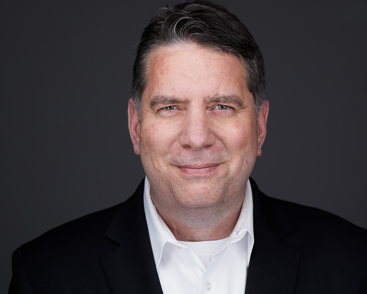 Male Professional Headshot with a black jacket and white shirt in Alexandria Virginia